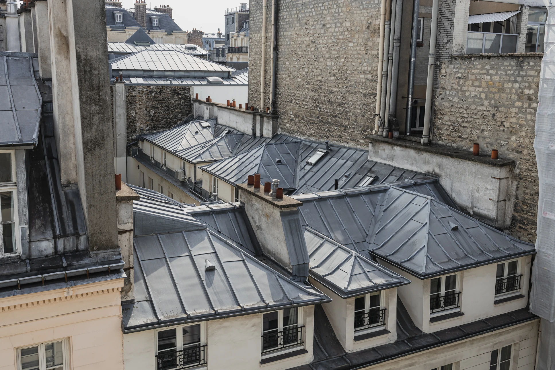 Combles en rénovation avec isolation thermique jaune entre chevrons apparents